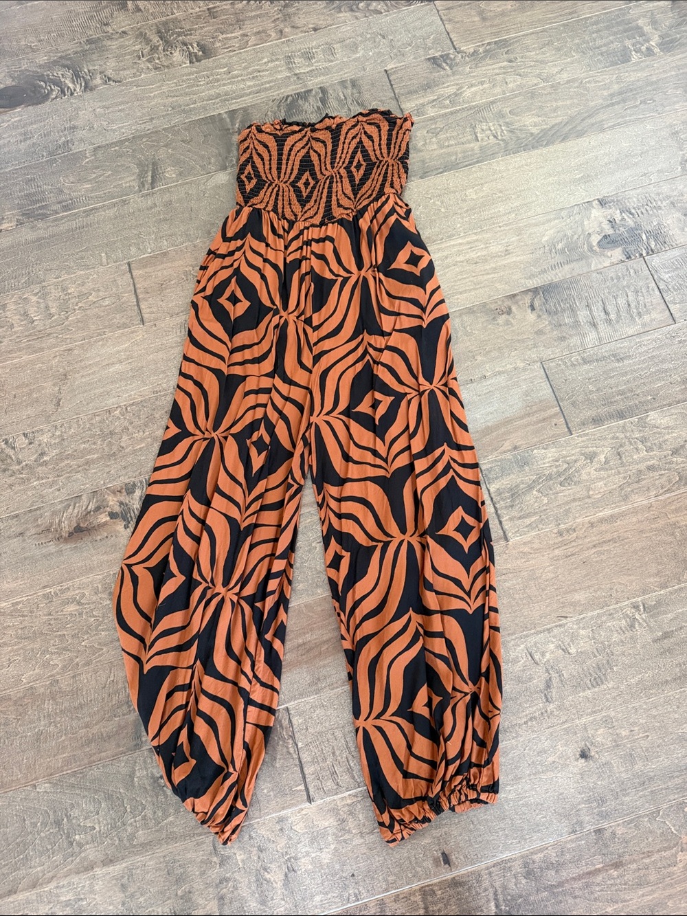 Anthropologie Strapless Smocked Wide-Leg Jumpsuit in Orange and Black